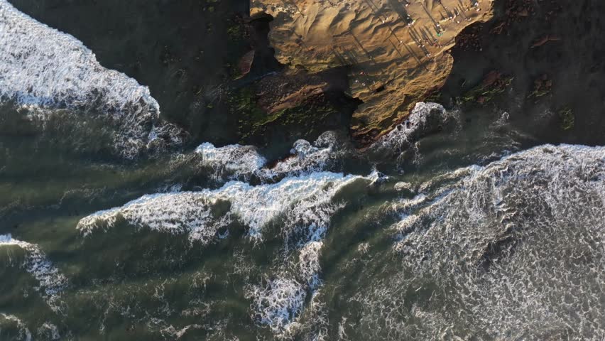 overhead view of the rocky shores at Sunset Cliffs in San Diego California with King Tide wave crashing along the rocky cliffs