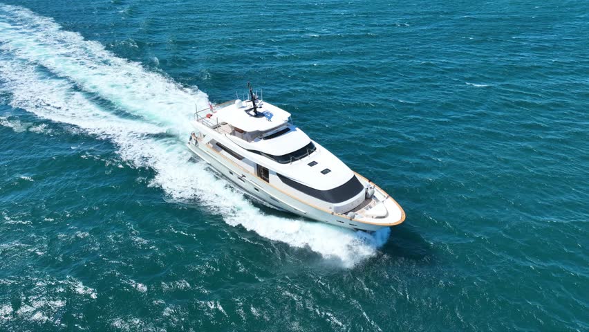 Aerial drone loop video of beautiful modern small yacht cruising in low speed in Aegean deep blue sea