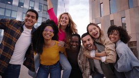 Group of diverse generation z piggyback joyful people having fun together posing excited in city. Happy young multiracial friends looking cheerful at camera standing in urban community outdoors - Powered by Shutterstock - Get 15% off with code: PIKWIZARD15