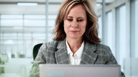 Businesswoman Working On Laptop At Office Desk, Drinking Coffee And Thinking - Powered by Shutterstock - Get 15% off with code: PIKWIZARD15