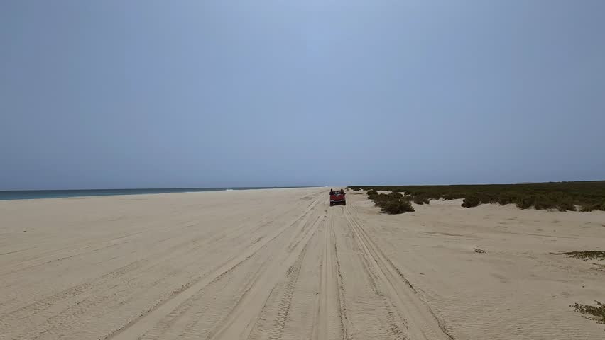 Following car while driving along Santa Monica beach on Boa Vista island, Cabo Verde. Car point of view