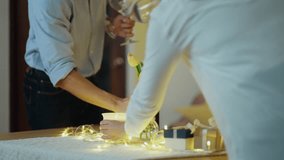 Both of young Asian couple  arrange table setting with wine glasses for their celebration day. - Powered by Shutterstock - Get 15% off with code: PIKWIZARD15