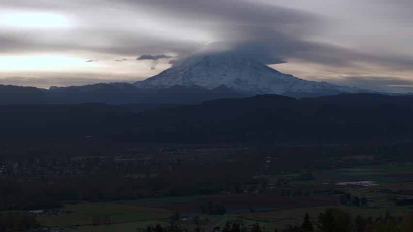 Mount Rainier with Low-Lying Clouds in Overcast Sky at Dusk