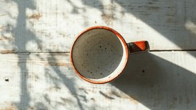 Empty Ceramic Mug Casting Shadow on Rustic Wooden Table - Powered by Shutterstock - Get 15% off with code: PIKWIZARD15