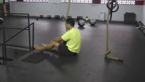 Athlete making leg less rope climb crossfit exercise.