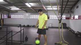 Athlete doing kettlebell clean and press crossfit exercise.