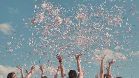 Friends celebrating joyfully outdoors, throwing colorful confetti under a blue sky. Arms raised in excitement, surrounded by a cheerful atmosphere - Powered by Shutterstock - Get 15% off with code: PIKWIZARD15