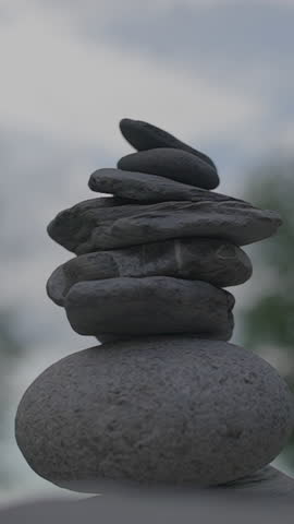 A Carefully Arranged Stack of Smooth Stones Sitting Gracefully on a Tranquil Background