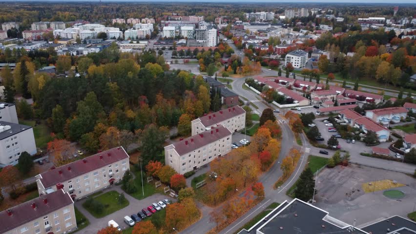 Flyover of Kerava, Finland with trees in vibrant autumn colours