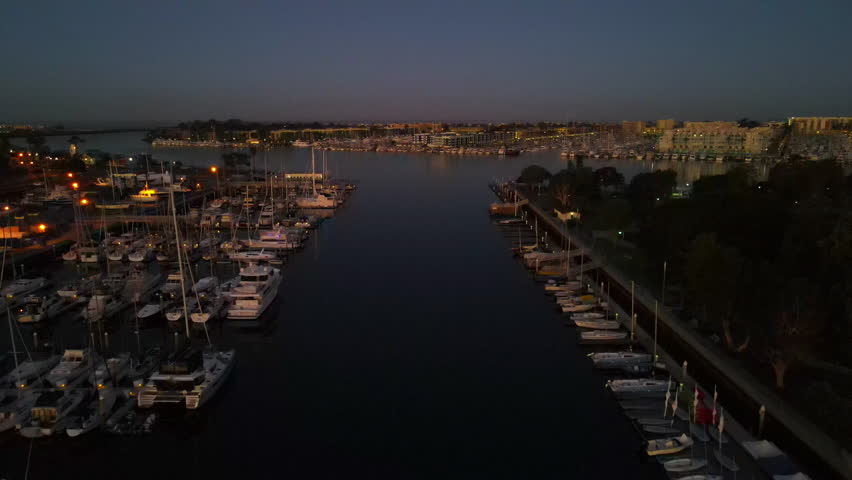 Early morning drone shot of a harbor in Long Beach, California with water and sailboats