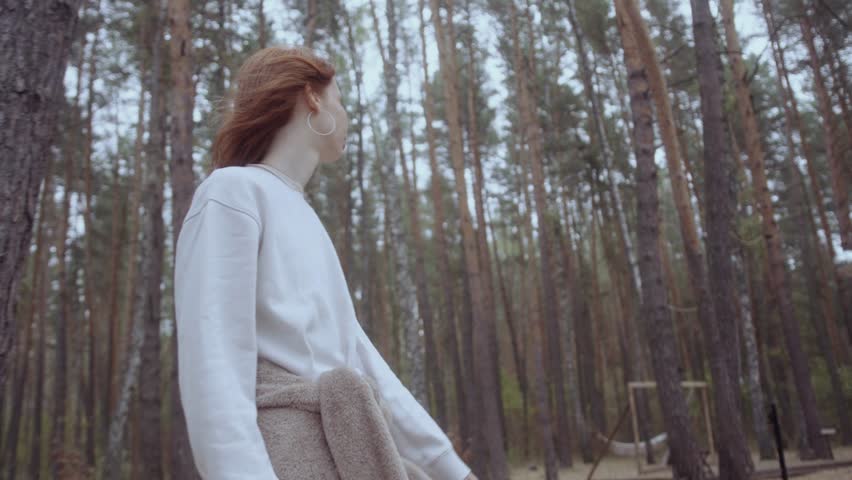 Young woman walks through natural forest. Active lifestyle. 