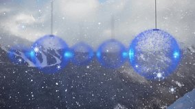 Animation of snow falling over mountains and christmas baubles. Pattern, season and digital interface concept digitally generated video. - Powered by Shutterstock - Get 15% off with code: PIKWIZARD15