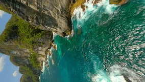 Vertical video. Cinematic FPV flight over turquoise ocean waters at Manta Point on Nusa Penida, Bali, Indonesia - Powered by Shutterstock - Get 15% off with code: PIKWIZARD15
