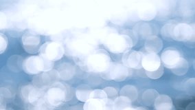 Abstract sea view on a sunny summer day. Blurred nature background. Lots of white round bokeh spots reflecting sun glare on the blue surface of sea waves. Nature. - Powered by Shutterstock - Get 15% off with code: PIKWIZARD15