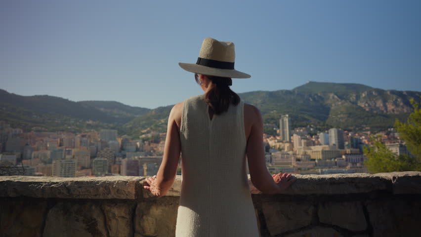 Person Overlooking City and Mountains