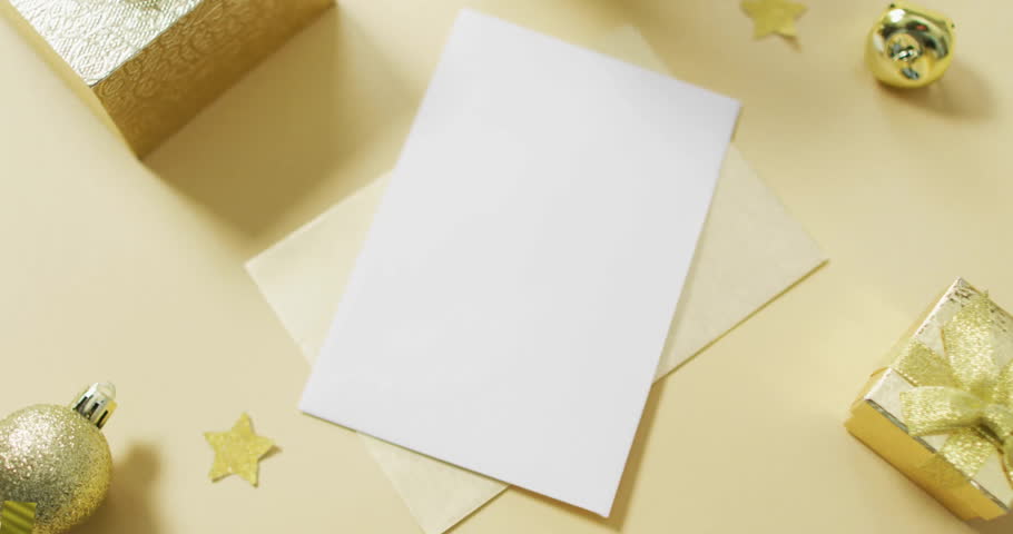 Golden confetti animation over blank card and envelope on festive background. Celebration, party, holiday, decoration