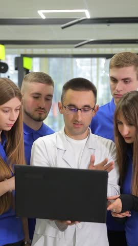A doctor analyzes data in a gym, showcasing teamwork in fitness. Vertical video