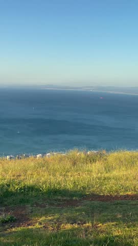 Man taking in the breathtaking views of Cape Town from Signal hill on a beautiful summer day.