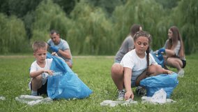 Family volunteers cleaning environment. Children adults collecting rubbish. Volunteers picking up rubbish protect environment. Family teamwork environmental cleanup. kids responsibility environment. - Powered by Shutterstock - Get 15% off with code: PIKWIZARD15