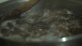Mushrooms Boiling in a Large Pot, Stirred with a Wooden Spoon - Powered by Shutterstock - Get 15% off with code: PIKWIZARD15