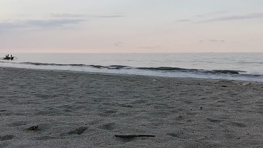This image captures a small fishing boat on calm waters, silhouetted against a soft, pastel sky at dusk. The horizon is barely visible, blending seamlessly with the tranquil sea. 