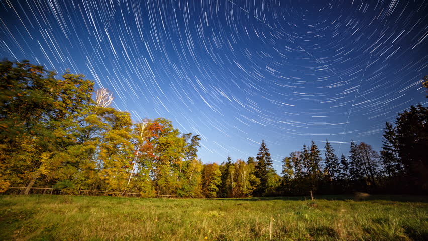 Night time lapse with startrails and autumn landscape.