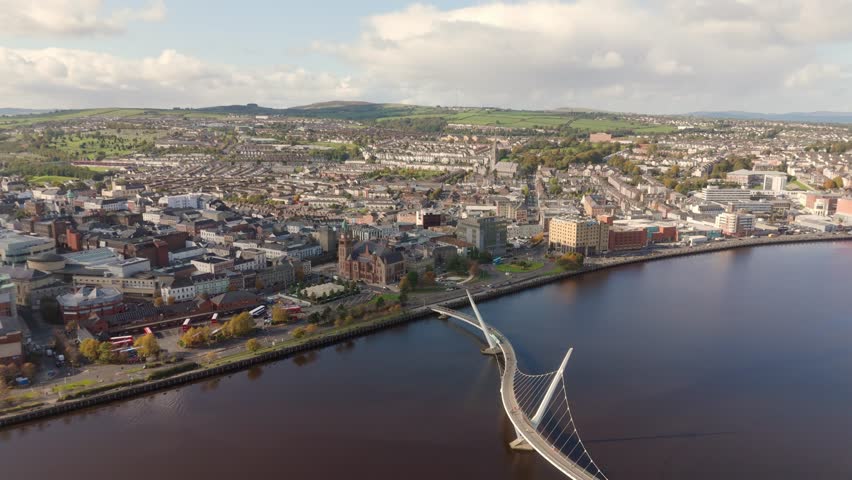 City of Derry aka Londonderry in Northern Ireland aerial view - A Beautiful Cityscape from above by the River Foyle Featuring the Beautiful Pedestrian Peace Bridge