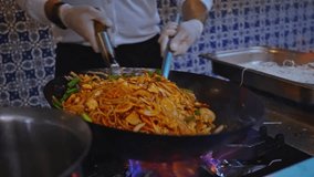 Professional chef cook making noodles in wok. - Powered by Shutterstock - Get 15% off with code: PIKWIZARD15