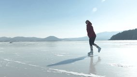SLOW MOTION, COPY SPACE: Cheerful woman wearing a red jacket and sunglasses ice skates across the frozen lake on a sunny winter day. Happy female tourist in red ice skating in the alpine landscape. - Powered by Shutterstock - Get 15% off with code: PIKWIZARD15