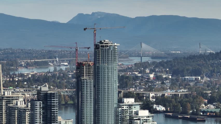 An aerial view of the Pier West towers under construction, with the city in the background in New Westminster, British Columbia, Canada