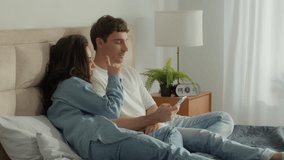 Couple lying bed resting bedroom man woman talk mobile phone smartphone together female male boyfriend girlfriend weekend networking online conversation chat discussing relax technology digital gadget - Powered by Shutterstock - Get 15% off with code: PIKWIZARD15