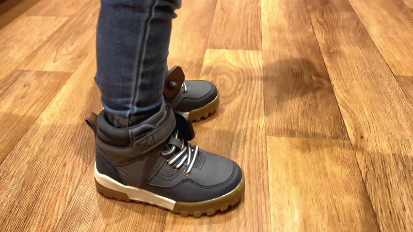 Little boy at shop.kid baby put on,wearing,choosing,buying new sneakers shoes.shopping, children's clothes, fashion outfit,paternity, happy family 4k.