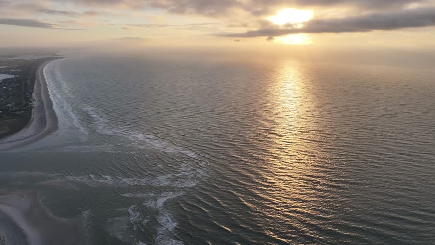 Aerial View of Wrightsville Beach at the north end. A 360 starting at the north end of Wrightsville Beach at Murrels Inlet with a view that pans to Wrightsville Beach at sunrise. 