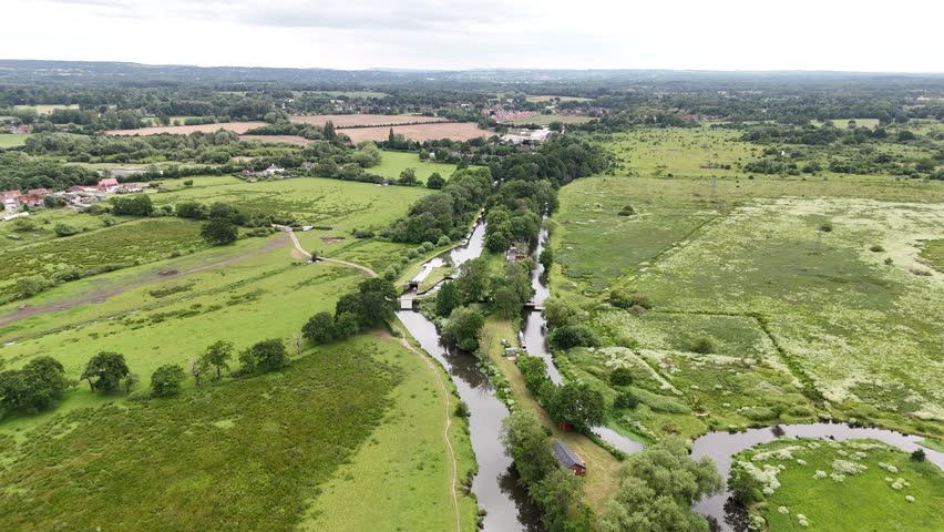 A drone view of the Wey Navigation winds through the Surrey countryside at Ripley on a sunny day in England