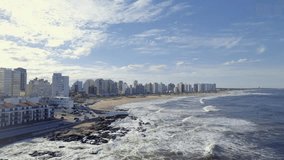 An aerial footage of El Emir beach and Brava Beach with the urban buildings in the background on a sunny day in Punta del Este city, Uruguay - Powered by Shutterstock - Get 15% off with code: PIKWIZARD15