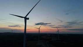 Scenic Aerial view of wind turbines farm in sunset time. Wind turbine producing alternative energy - Powered by Shutterstock - Get 15% off with code: PIKWIZARD15