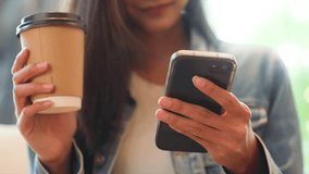Young asian beautiful woman using smart phone in coffee shop cafe, typing write message on mobile, online shopping, transfer payment, internet banking - Powered by Shutterstock - Get 15% off with code: PIKWIZARD15