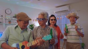 Group of Asian senior friend having evening party in living room at home. Mature elderly man and woman having fun, dancing with cool music while celebrate weekend reunion gathered together in house. - Powered by Shutterstock - Get 15% off with code: PIKWIZARD15