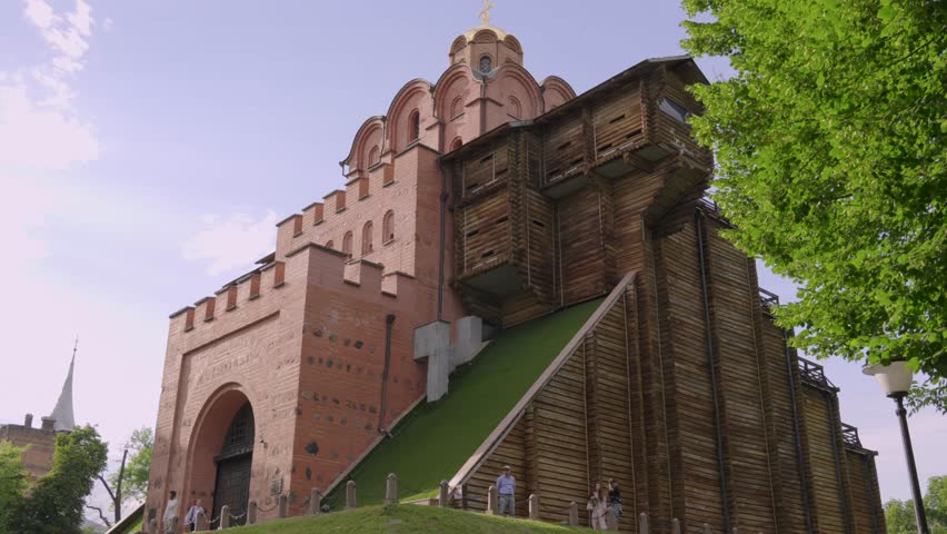 The people visiting the Golden Gate of Kyiv "the main gate in the 11th century" with blue clear sky in the background, Ukraine