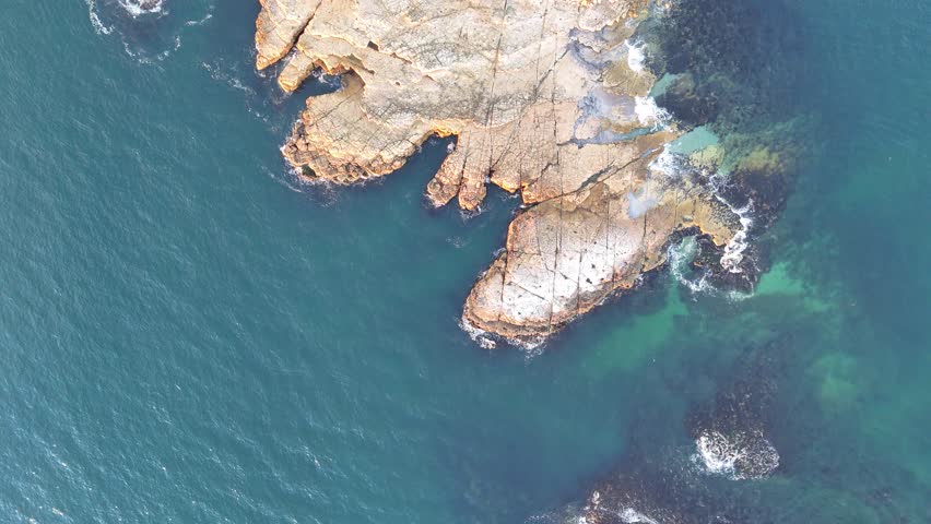 An aerial of the Iron Pot lighthouse and island at dawn surrounded by the waters of River Derwent in Australia