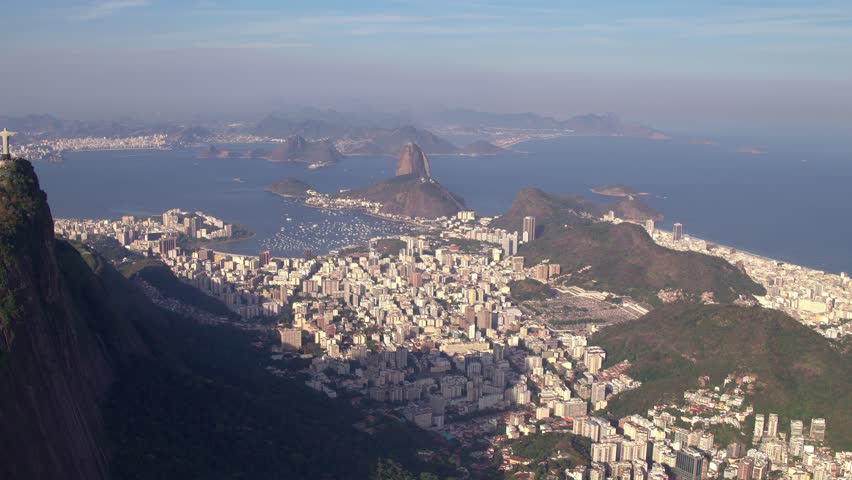 An aerial footage of the Christ the Redeemer (Cristo Redentor) overlooking the city of Rio de Janeiro on a sunny day, Brazil