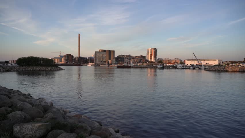 The stunning skyline of Malmo, Sweden with a brilliant blue sky, waterfront and towering buildings