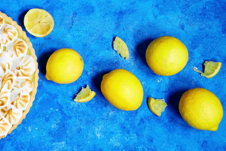 Traditional french lemon Meringue tart on blue grunge background