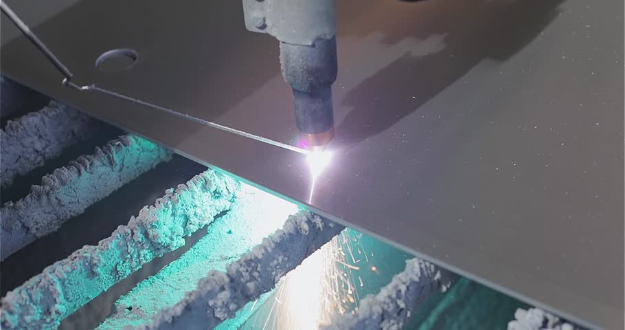 The process of cutting a metal part with a plasma cutter. Plasma cutting. Plasma cutter work at the factory. The plasma cutter will cut the part.