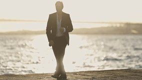 Businessman dancing by the sea at sunset - Powered by Shutterstock - Get 15% off with code: PIKWIZARD15