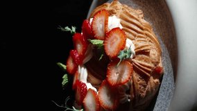 Top view of delicious dessert garnished with fresh strawberries and mint leaves. Perfect for breakfast or brunch. vertical video - Powered by Shutterstock - Get 15% off with code: PIKWIZARD15