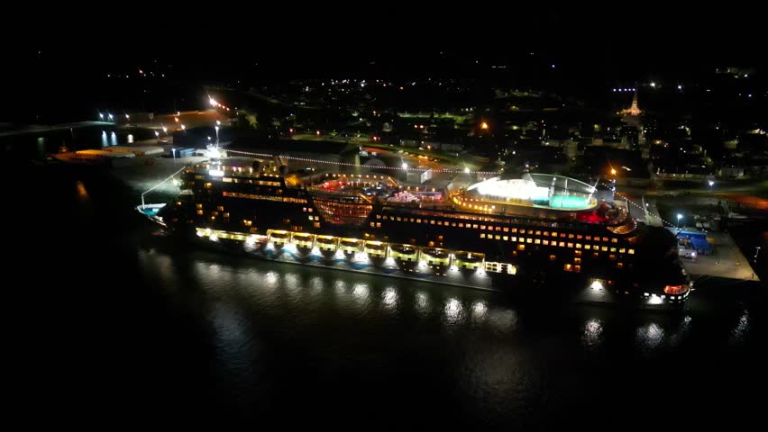 cruise ship docked port night beautifully illuminated against dark waters invergordon serene circling aerial drone shot moored travel holiday adventure vessel harbor scenic nature