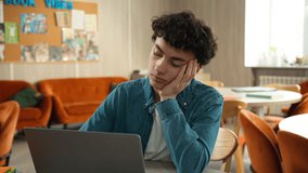 Stressed upset boring lazy Caucasian male boy teen exhausted fatigued Hispanic guy pupil man teenager e-learning studying online internet laptop computer homework at school university college boredom - Powered by Shutterstock - Get 15% off with code: PIKWIZARD15