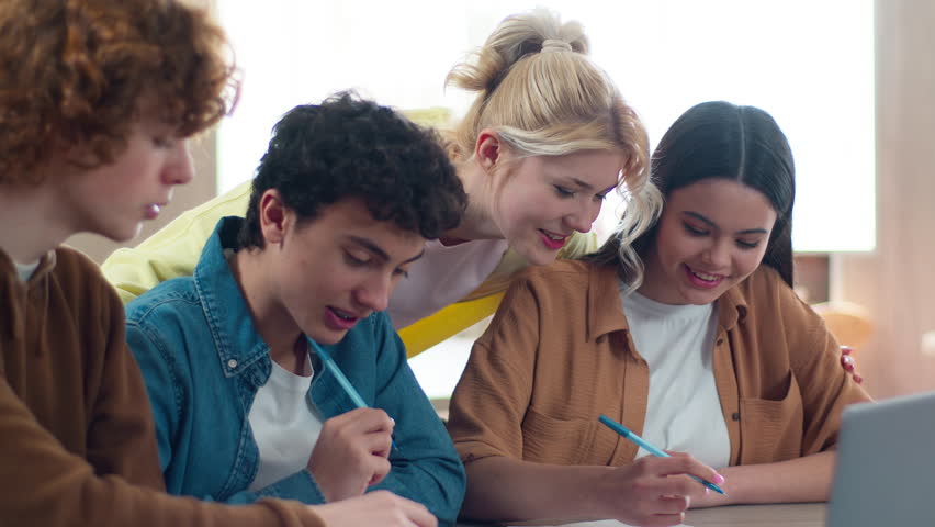 Four Caucasian students teens teenagers friends pupils male female boys guys girls women men studying together learning study e-learning education teamwork cooperate laptop at school writing homework - Powered by Shutterstock - Get 15% off with code: PIKWIZARD15