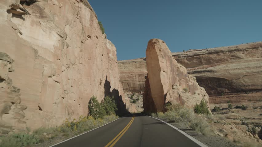 Colorado National Monument Park near the city of Grand Junction. Sheer-walled, Red rock canyons, Rim Rock Drive, Towering monoliths within a vast plateau and canyon panorama USA